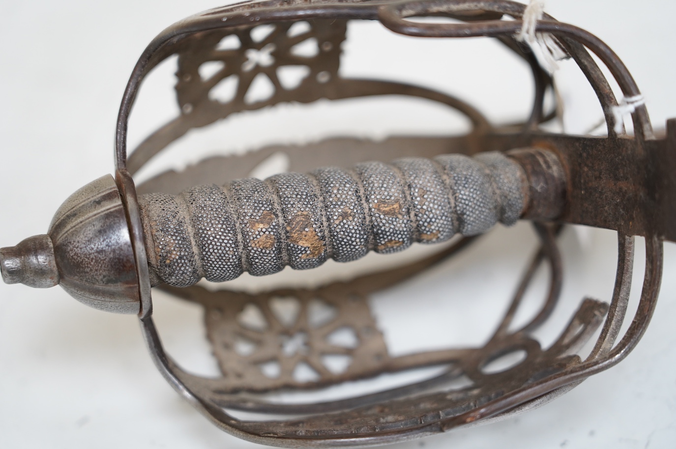 A late Victorian officer’s sword of the Black Watch, claymore blade etched with regimental title and VR cipher, regulation basket hilt, fish skin covered grip, in its leather covered field service scabbard, blade 82cm. C